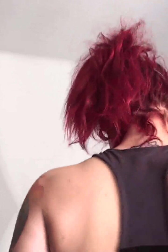 Giant tattooed redhead walks her slave around the room while smoking