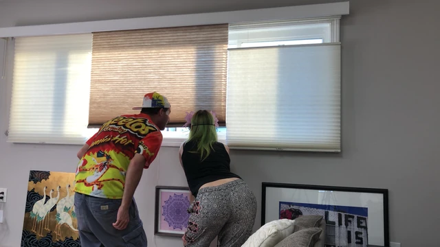 Couple Peeping Outside Apartment Window