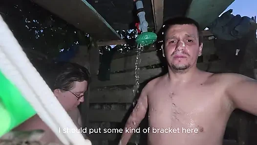 Soapy naked bodies in a rural shower