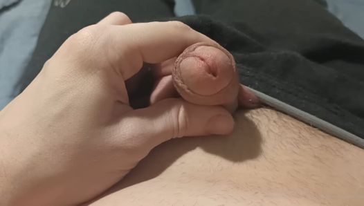 The guy plays with his penis head, back and forth, foreskin
