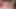 セクシーなブルネットの女性がバイブレーターでベッドでマスターベーションをしている