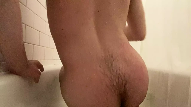 Teen boy rubs one out in the tub.
