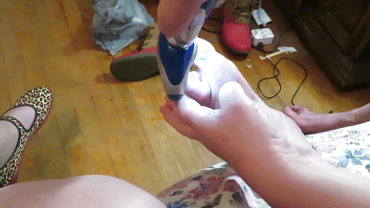 Nurse Vicki grinds her toe nails down with her electric Pedi egg tool ! Poor ugly toes need it real bad!