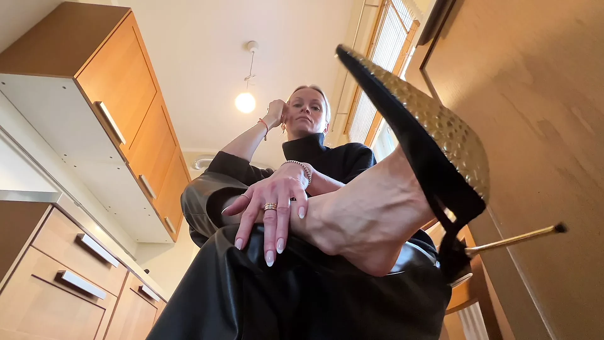 Dangling and shoe playing in my black stiletto mules and leather pants.