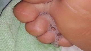 Spitting on girlfriends feet