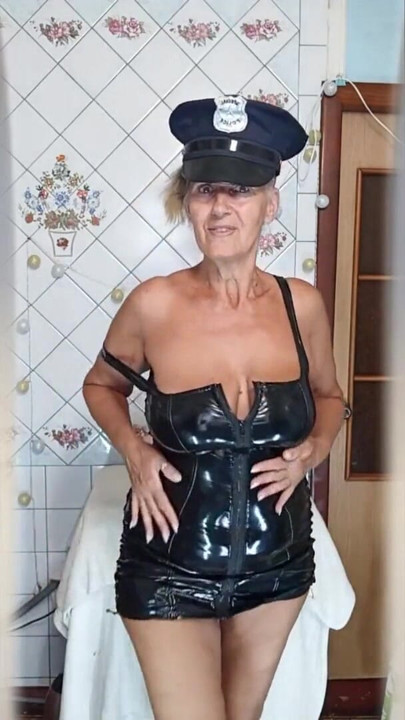 An elderly lady in the kitchen wearing an attractive suit | Clip 1