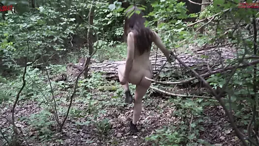 Mel walks naked in the woods