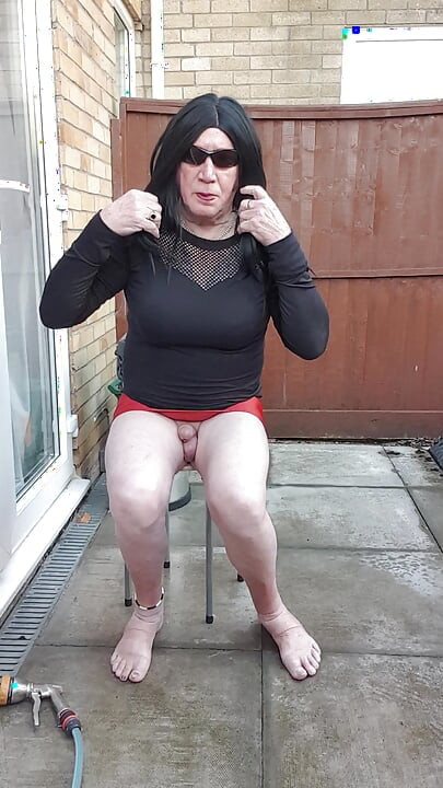 Dressed Gurl Spraying Her Bare Legs With Ice Cold Water