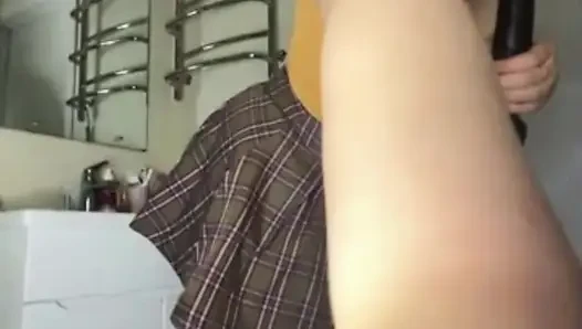 A chubby girl in a college skirt fucks herself