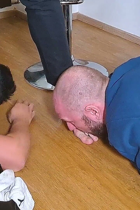 Managerial Control: Businessman Boman Steps Barefoot on Slave Ben