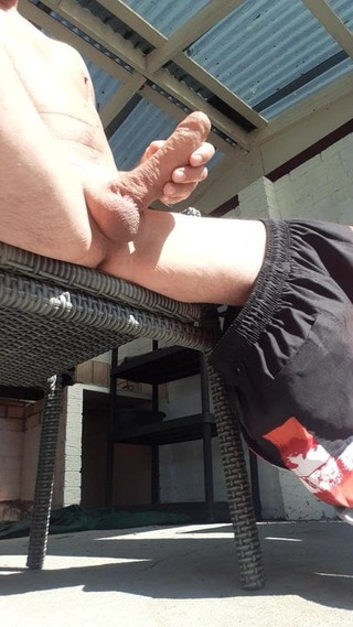 Playing on kik with my cock outside in the sun