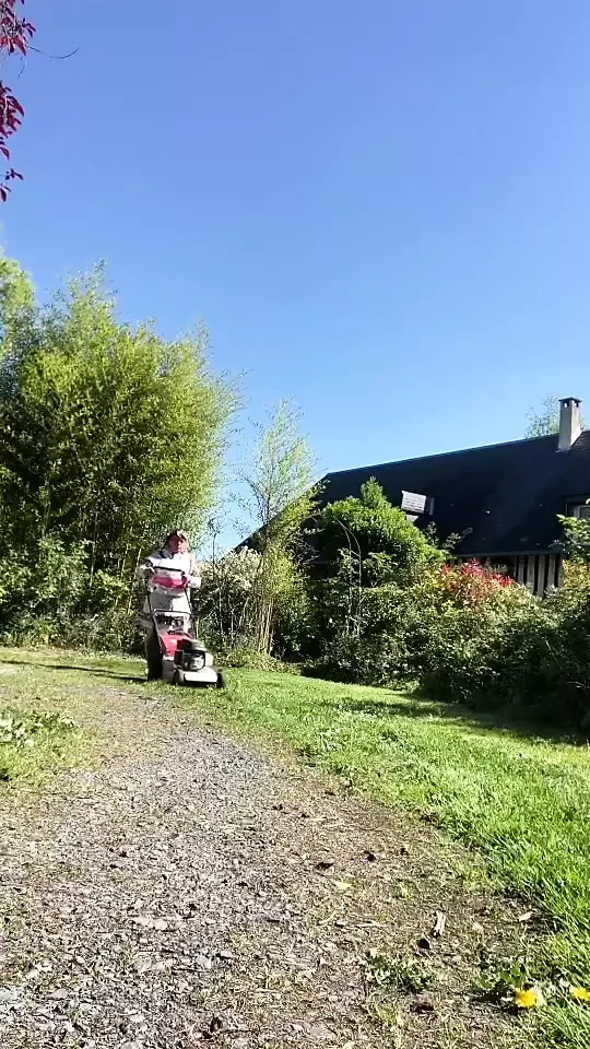 In gardening attire with a layer to mow the lawn.