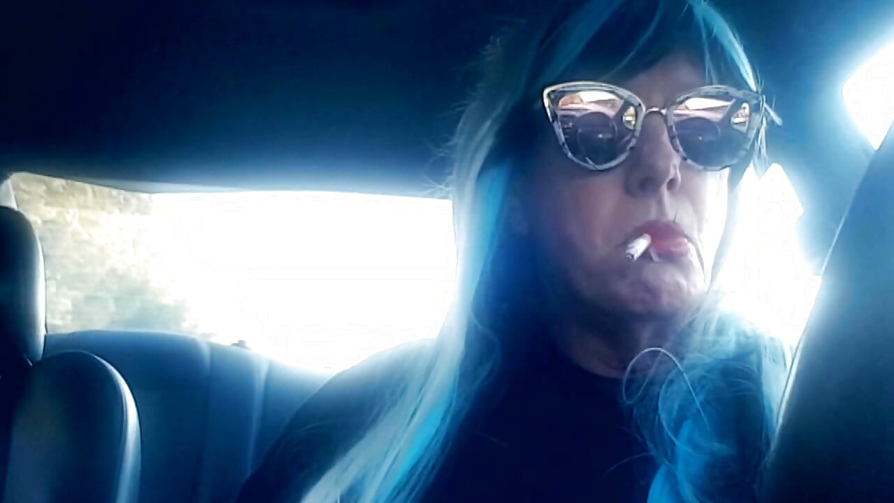 MATURE CD SMOKING & DRIVING WITH A MB100 CIGARETTE IN HER GLOVED HAND