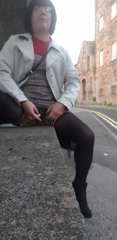 Crossdressing slut exposes her caged cock on public street | Clip 1