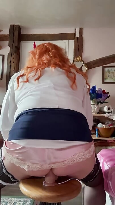 Wearing a short navy blue skirt to take a dildo