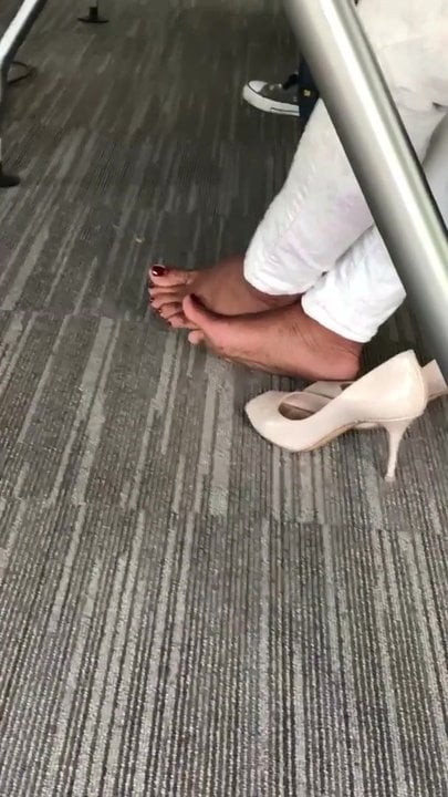 Playing feet during business meeting