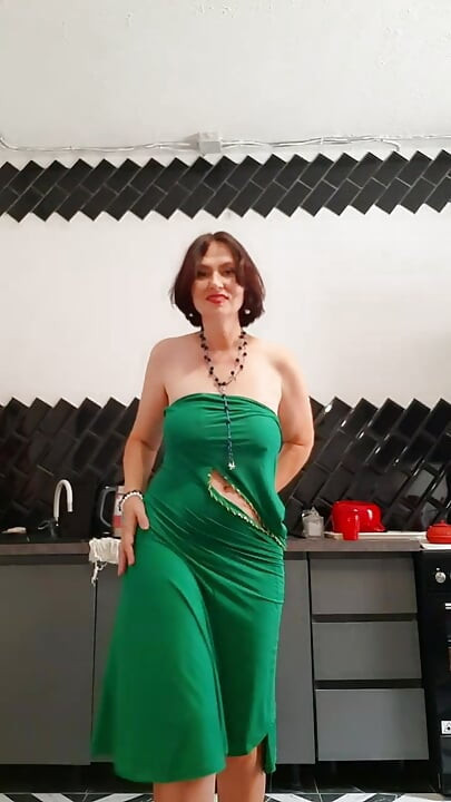 Her beautiful body is covered by a tight-fitting dress