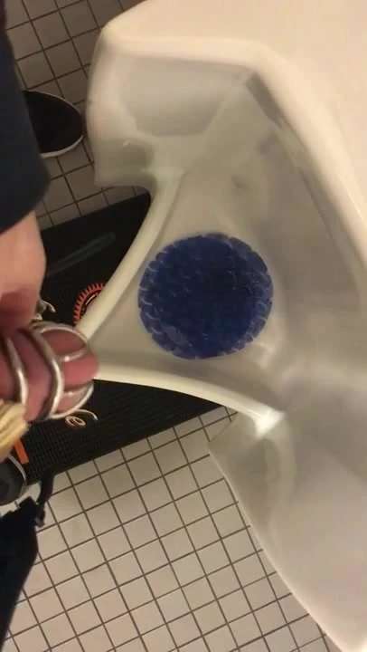 Chastity pissing in a public urinal
