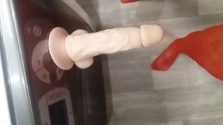 Realistic suction cup dildo on washing machine