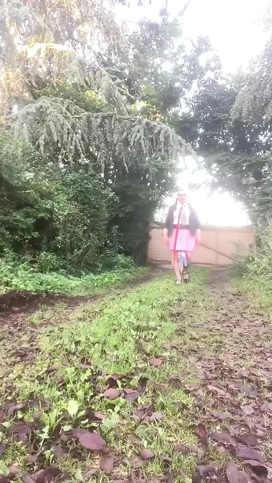 In school attire with a pink pleated skirt on the outside