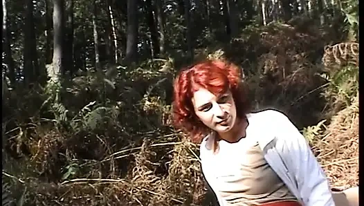 Redhead chick plays with her pussy outdoors