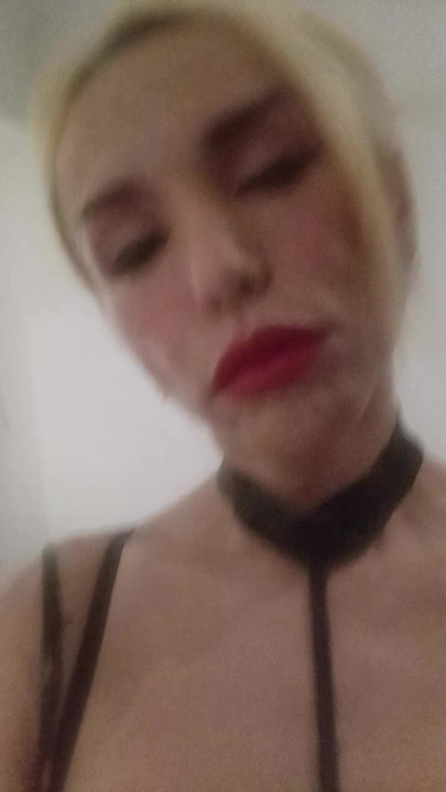 Transgender, shemale, ladyboy on her Black spandex, leather domination outfit. BDSM