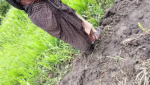 The desi daughter-in-law of the village is taking off her clothes in the millet field and showing her finger in her pussy to her father-in-law.