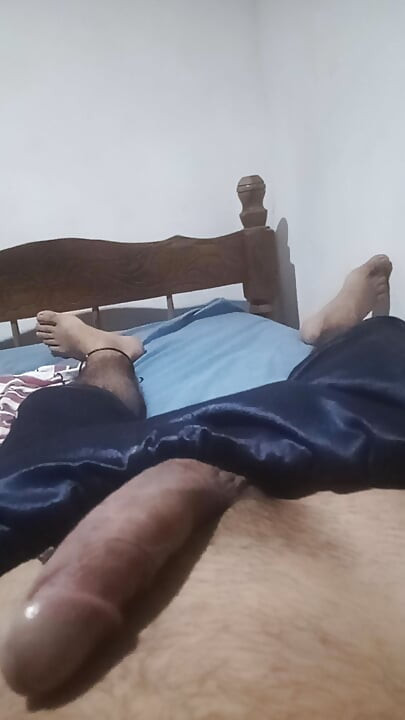Young man de-stresses with a in his room while his neighbors talk