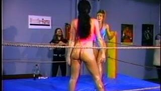 Naked females wrestle in a ring