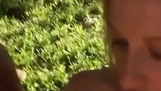 Guy grabs the blonde's tits as she's on her knees
