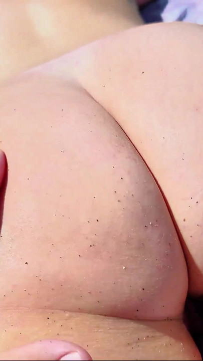 On a nudist beach, spanking her ass | Clip 2