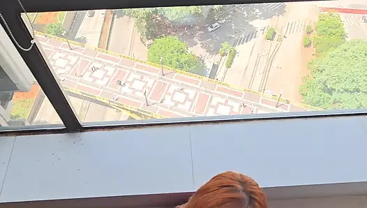 Gadis ini lagi asik di depan jendela mirante sampa sky di pusat kota são paulo sambil ditonton semua orang
