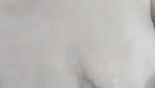 Hot mature woman relaxes in the bathroom and masturbates full of foam under the shower