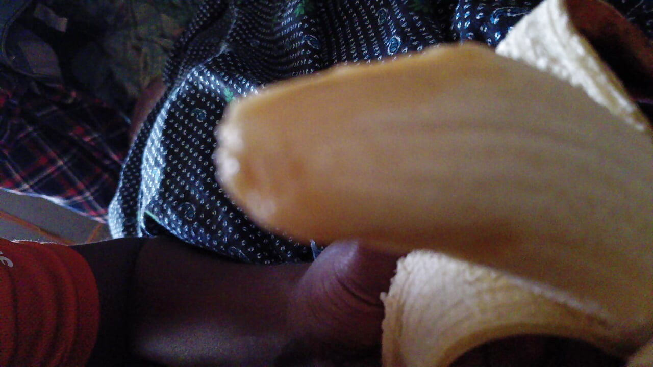 Indian Young boy eating banana at private room