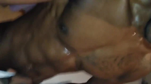Sweaty black man with glossy muscles