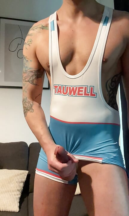 Smooth jock in wrestling singlet jerks off and cums