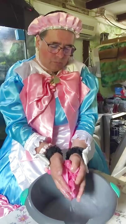 In a blue maid's outfit with pink bows to do the laundry.