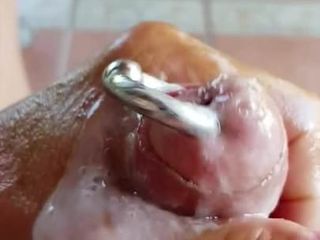 Wanking oiled pierced hard cock and cum