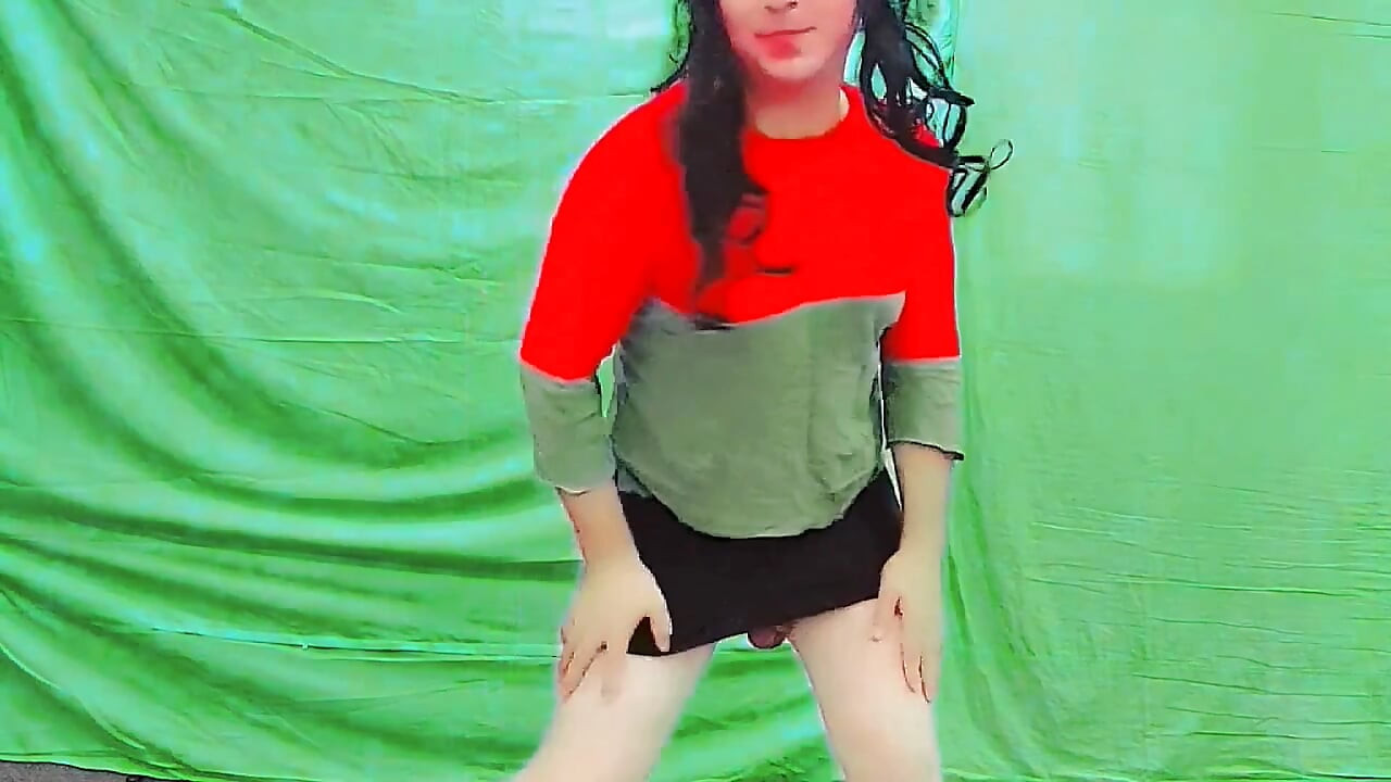Cute femboy lifting skirt slightly under soft lights
