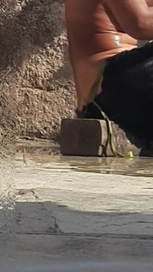 Indian sister-in-law is bathing in the open courtyard of the house, putting a finger in her burrow and rubbing the… | Clip 1