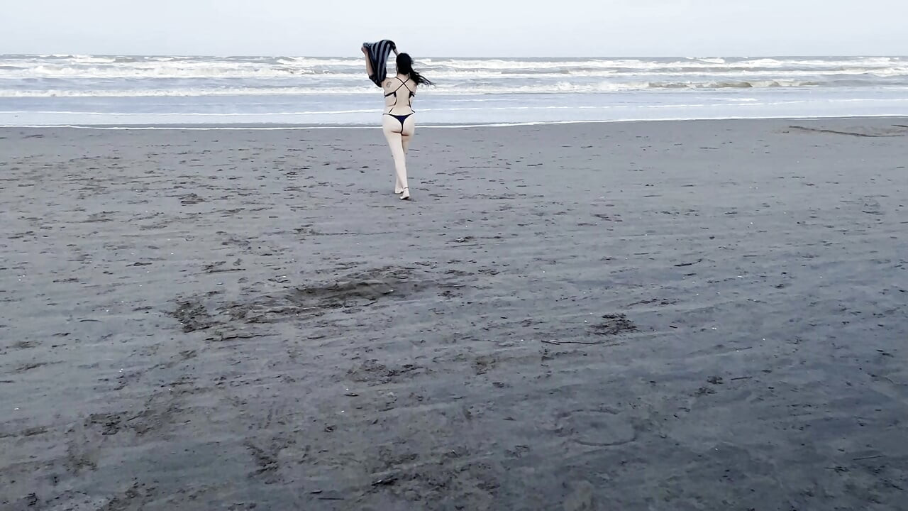 My neighbor loses her clothes at the beach.