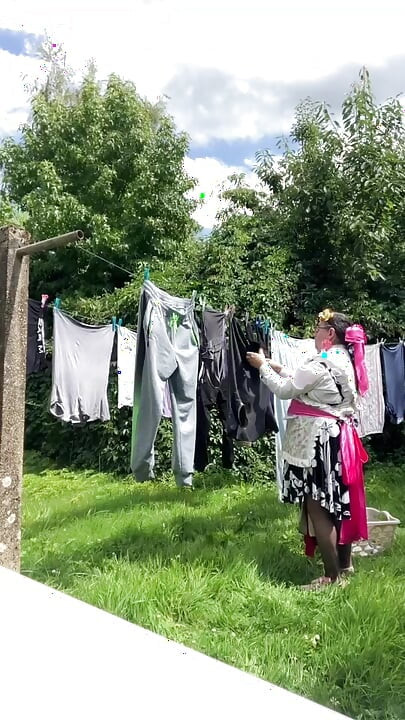 In gardening outfit to hang the laundry