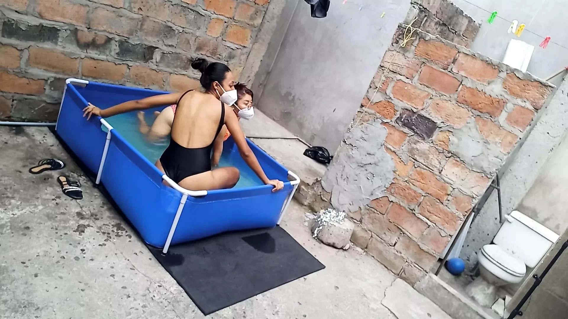 My neighbor is in the pool wearing a very tempting and sexy bikini. She's hot.