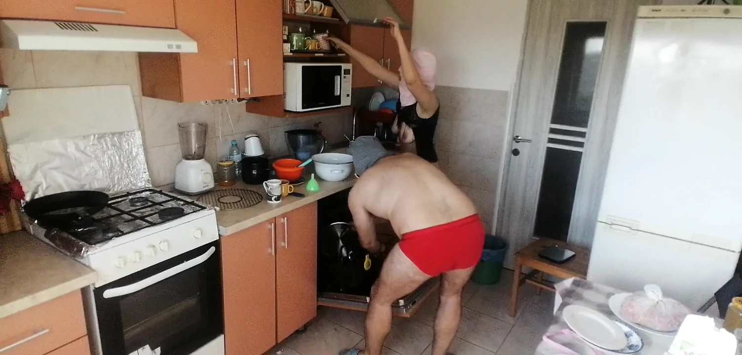 Couple Having Fun in the Kitchen. Sexy Wife Doing Chores in the House Naked