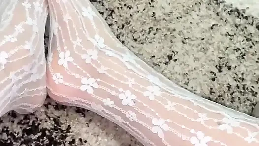 Massaging feet in sexy socks with hands in gloves