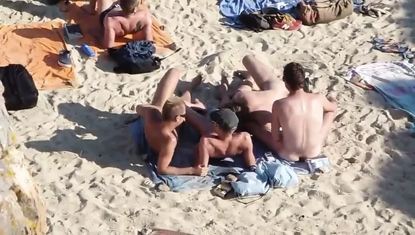 Group of guys having sex on the beach