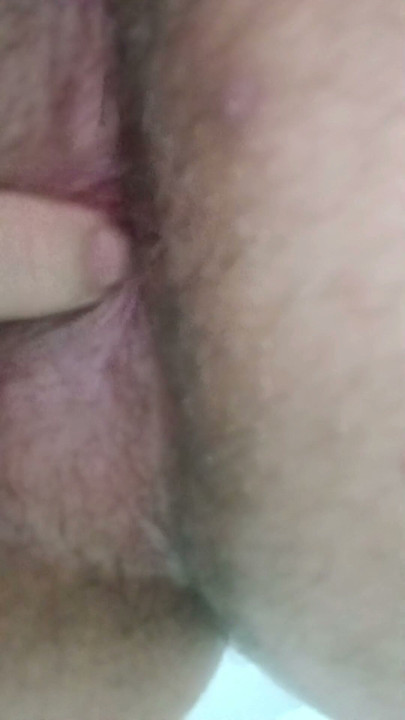 Scratching her ass with her fingertip