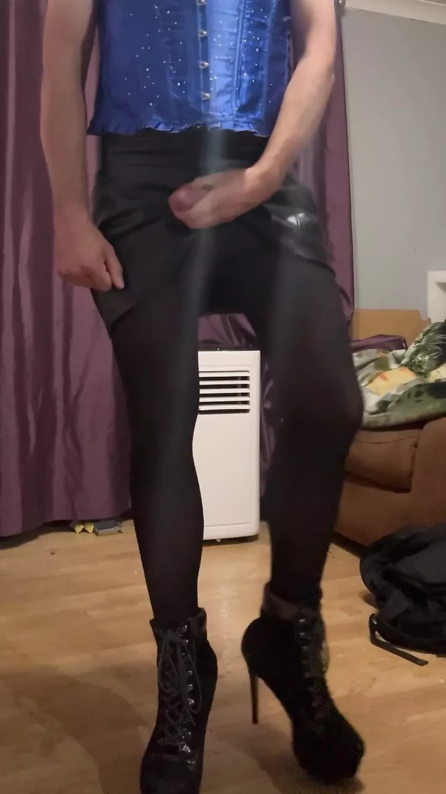 Maninboots edging dressed in blue corset, black skirt and high heel ankle boots. with multiple cumshots