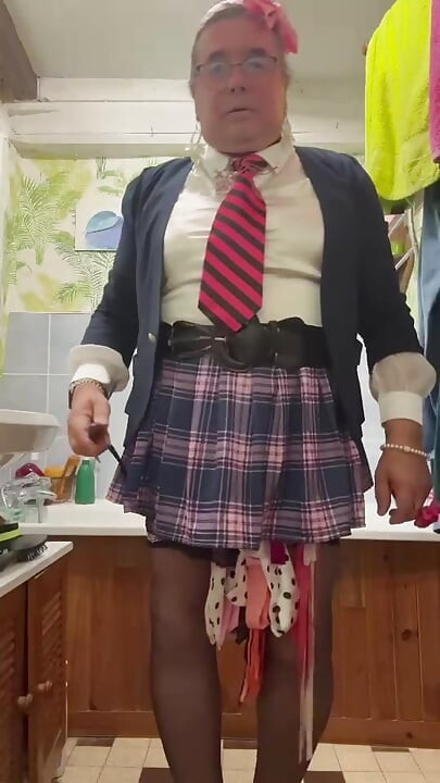 In an outfit with a little plaid skirt to pee in a bottle