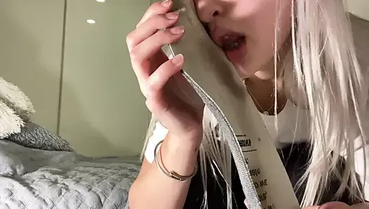 Cute girl sniffs her own shoes and nylon socks